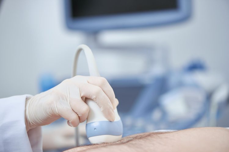 Crop closeup view of special medical device working with help of ultra sound and radiography. Planned observation with modern technologies preventing illnes. Concept of health care.