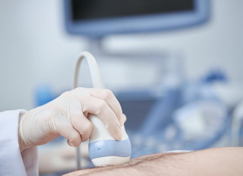 Crop closeup view of special medical device working with help of ultra sound and radiography. Planned observation with modern technologies preventing illnes. Concept of health care.